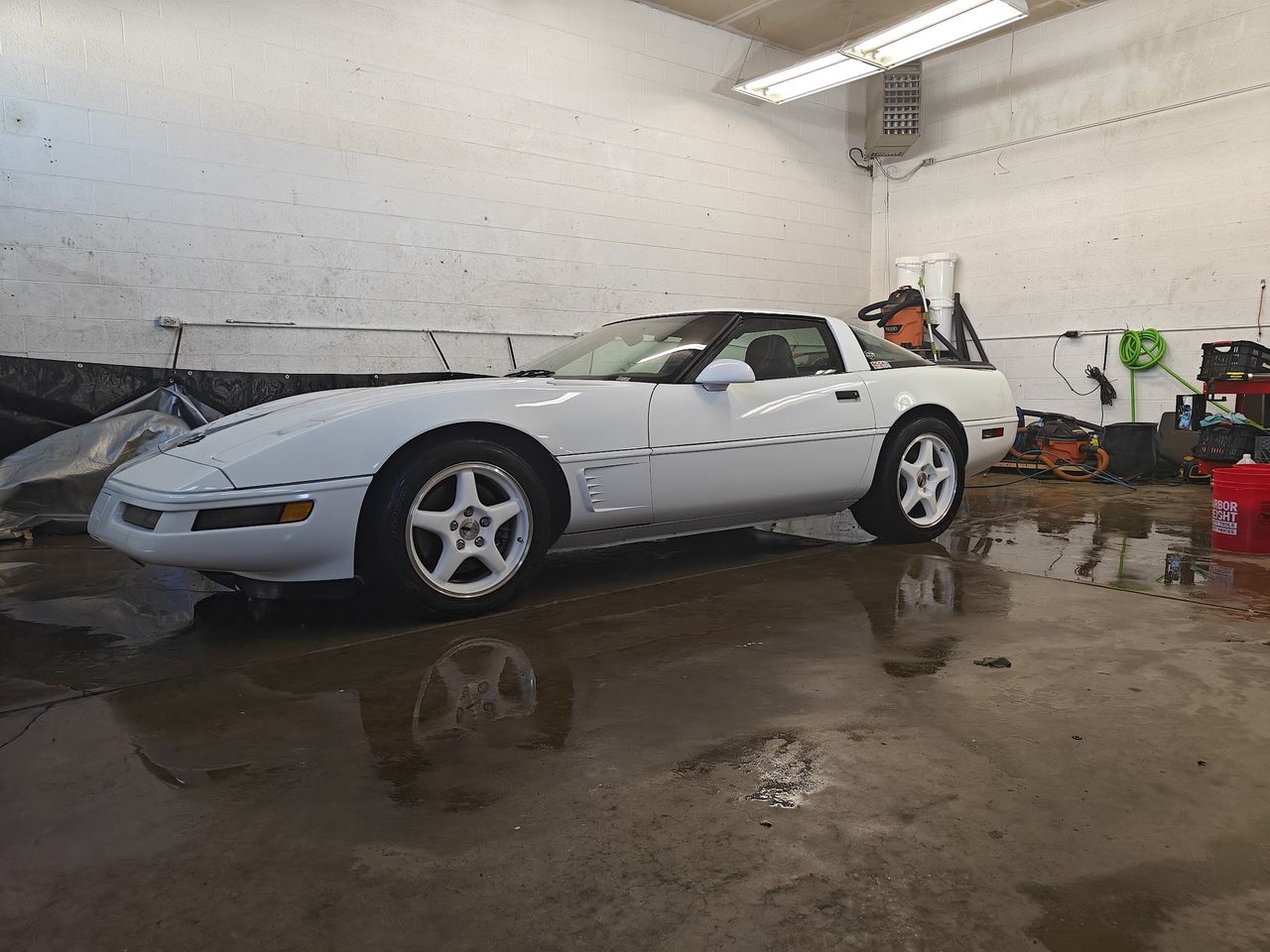 A white Chevrolet Corvette inside the Wolf Pack Repair shop in Pocatello, Idaho