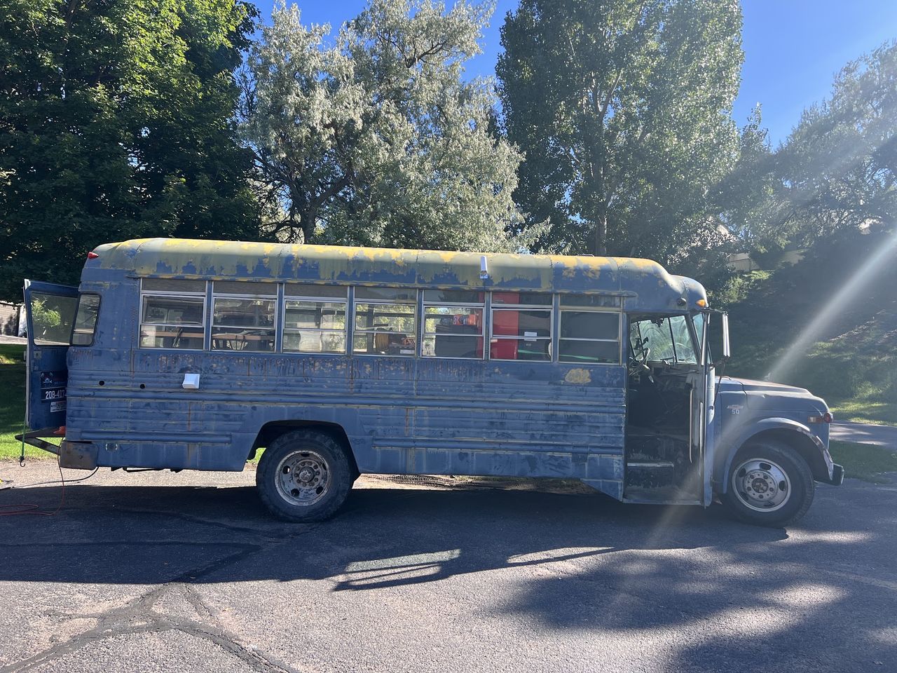 Wolf Pack Repair&rsquo;s blue Chevrolet service bus parked on a Pocatello street during a mobile job